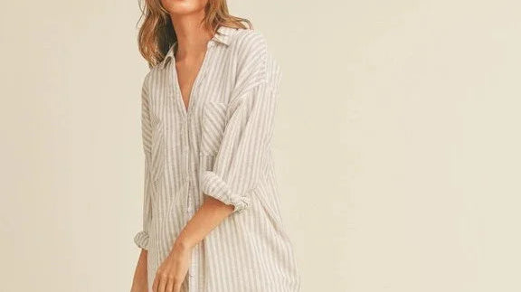 Woman wearing a loose striped shirt from Love Classic, showcasing casual high quality style.