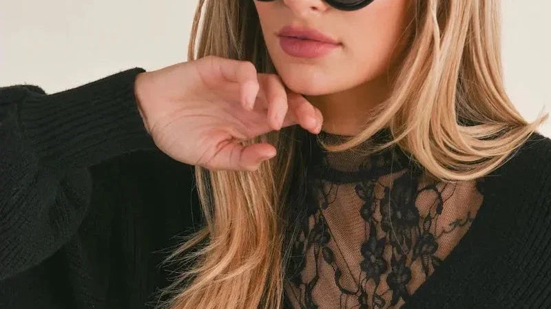 Woman in chic black cat eye sunglasses and lace top, Love Classic fashion style