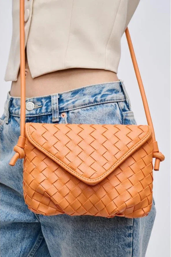 Woman wearing orange woven crossbody bag with denim jeans, high quality Love Classic style