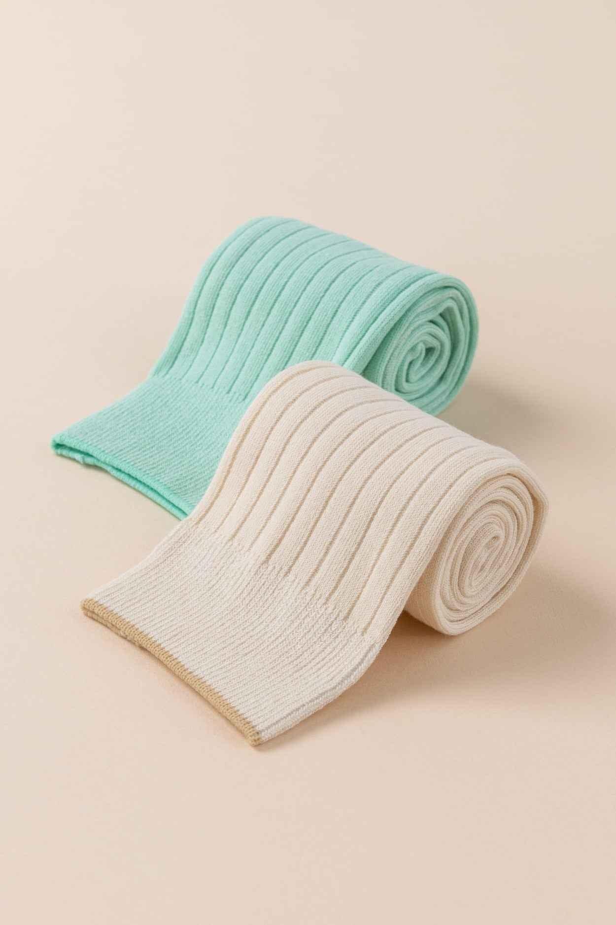 Love Classic ribbed knit socks in cream and mint green on a beige background
