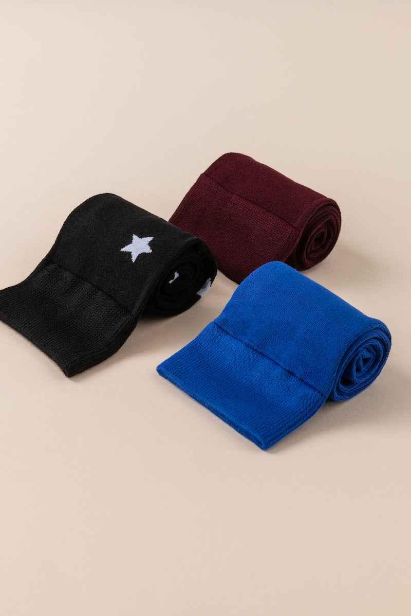 Love Classic rolled socks in black with white star, burgundy, and blue on beige background