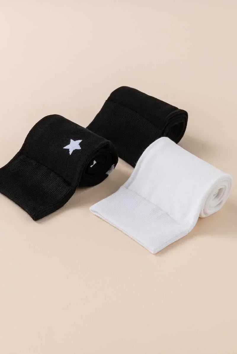 Love Classic high quality rolled black and white socks with star detail on neutral background