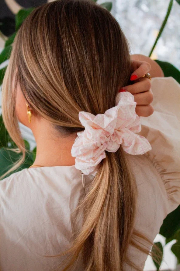 Woman with long hair wearing a pink plaid scrunchie, Love Classic hair accessory style