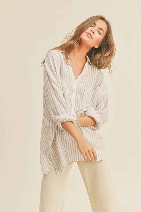 Woman wearing a relaxed striped button-up shirt and light pants, Love Classic fashion style