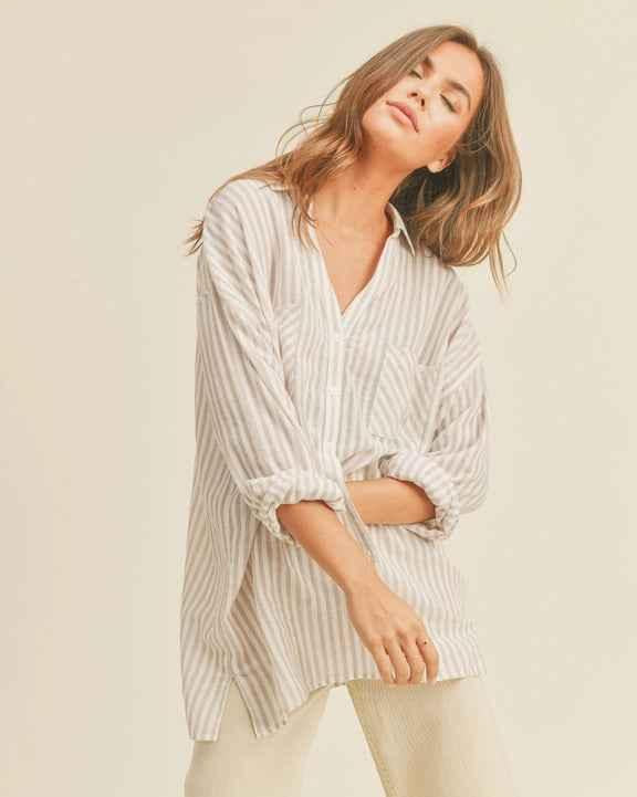 Woman wearing a relaxed striped button-up shirt and light pants, Love Classic fashion style