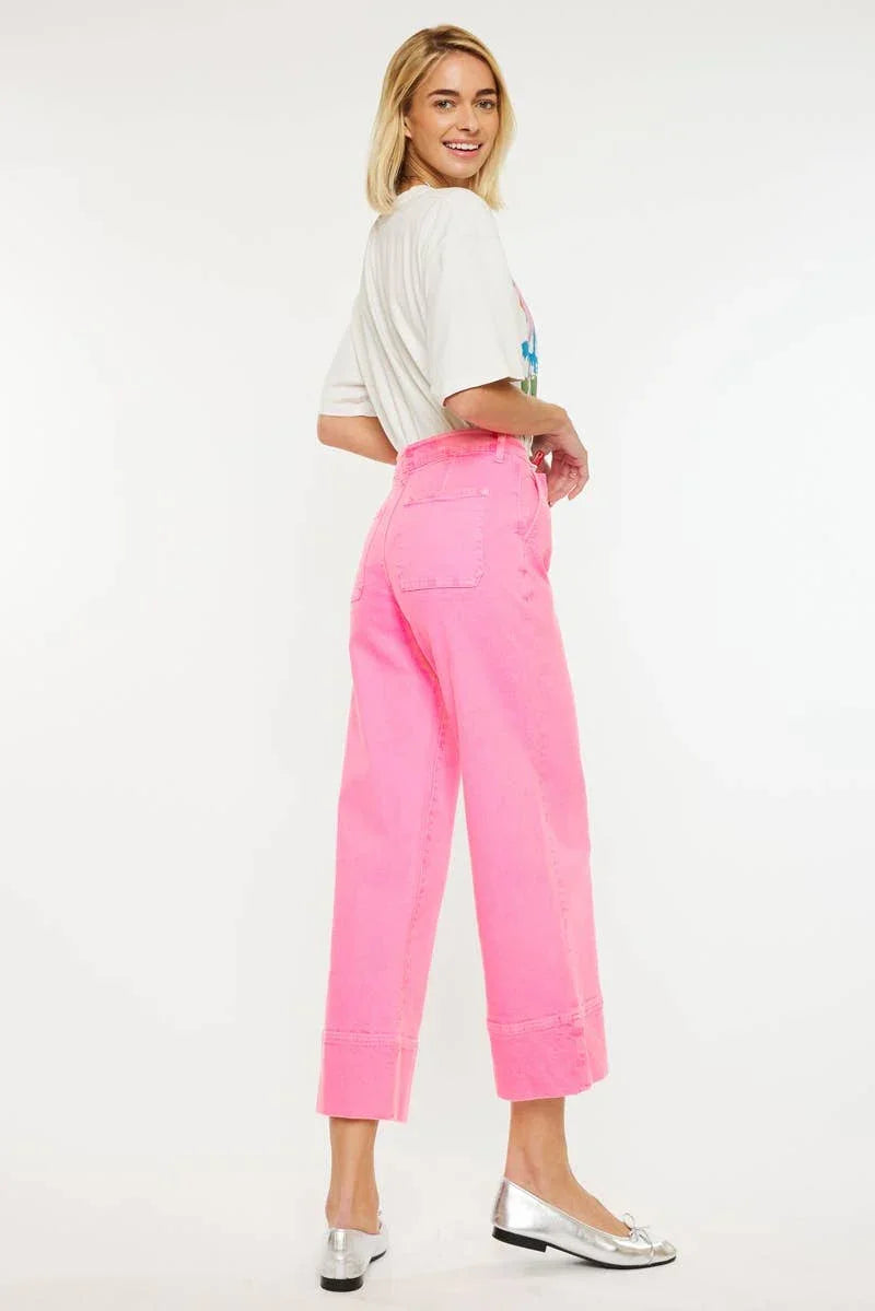 Woman modeling high-waisted pink jeans and white graphic tee, Love Classic fashion style