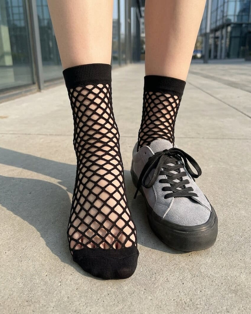 Bundled Pack, Midnight Lattice Fishnet Socks featuring bold fishnet mesh detailing with flexible stretch support and solid cuff accents, worn with casual sneakers outdoors in a contemporary city setting, highlighting breathable comfort and statement everyday wear.