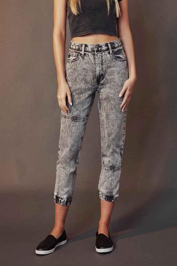 Woman wearing high-waisted acid wash jeans and black crop top, Love Classic fashion style