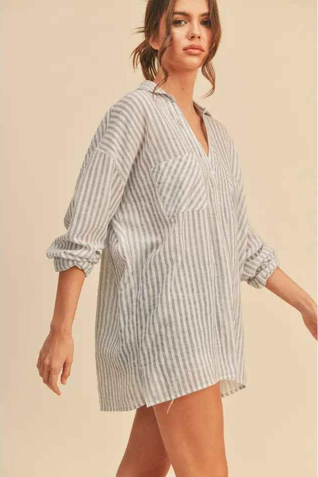 Woman wearing a loose striped shirt dress with rolled sleeves from Love Classic