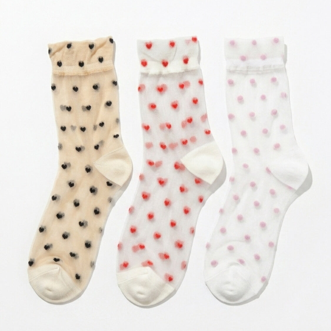3-Pack Blushing Hearts Sheer Socks featuring three sheer ankle socks with black heart, red heart and soft dot accents, displayed flat on a clean studio background, highlighting the assorted pack variety and lightweight translucent finish.