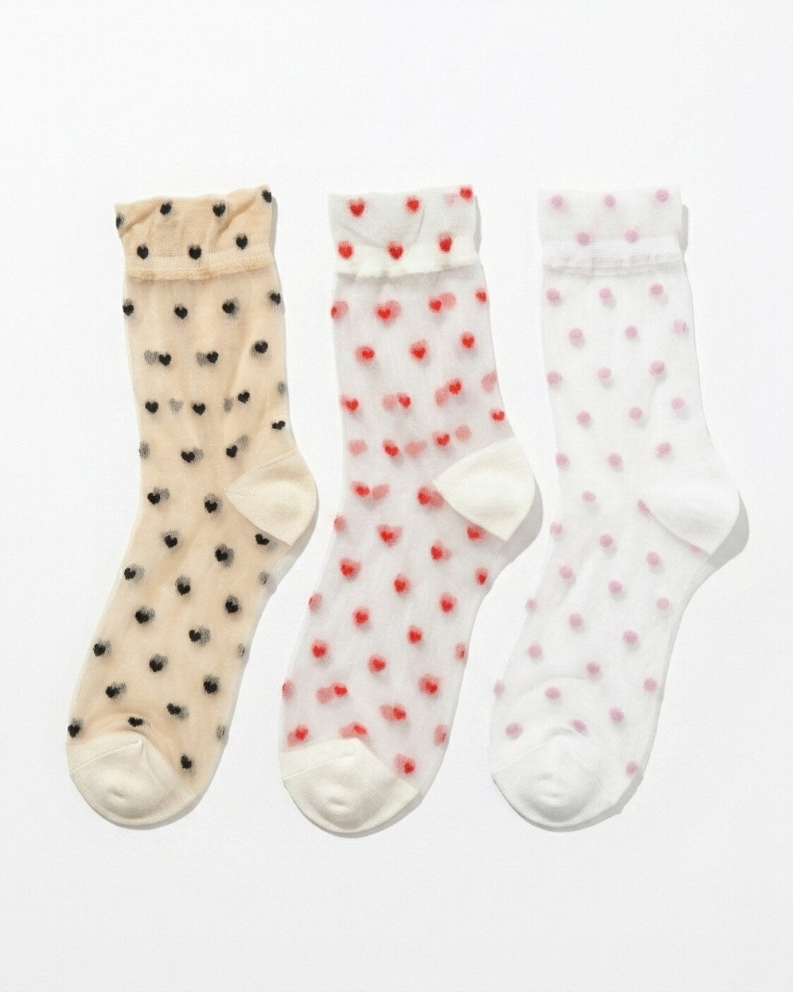 3-Pack Blushing Hearts Sheer Socks featuring three sheer ankle socks with black heart, red heart and soft dot accents, displayed flat on a clean studio background, highlighting the assorted pack variety and lightweight translucent finish.