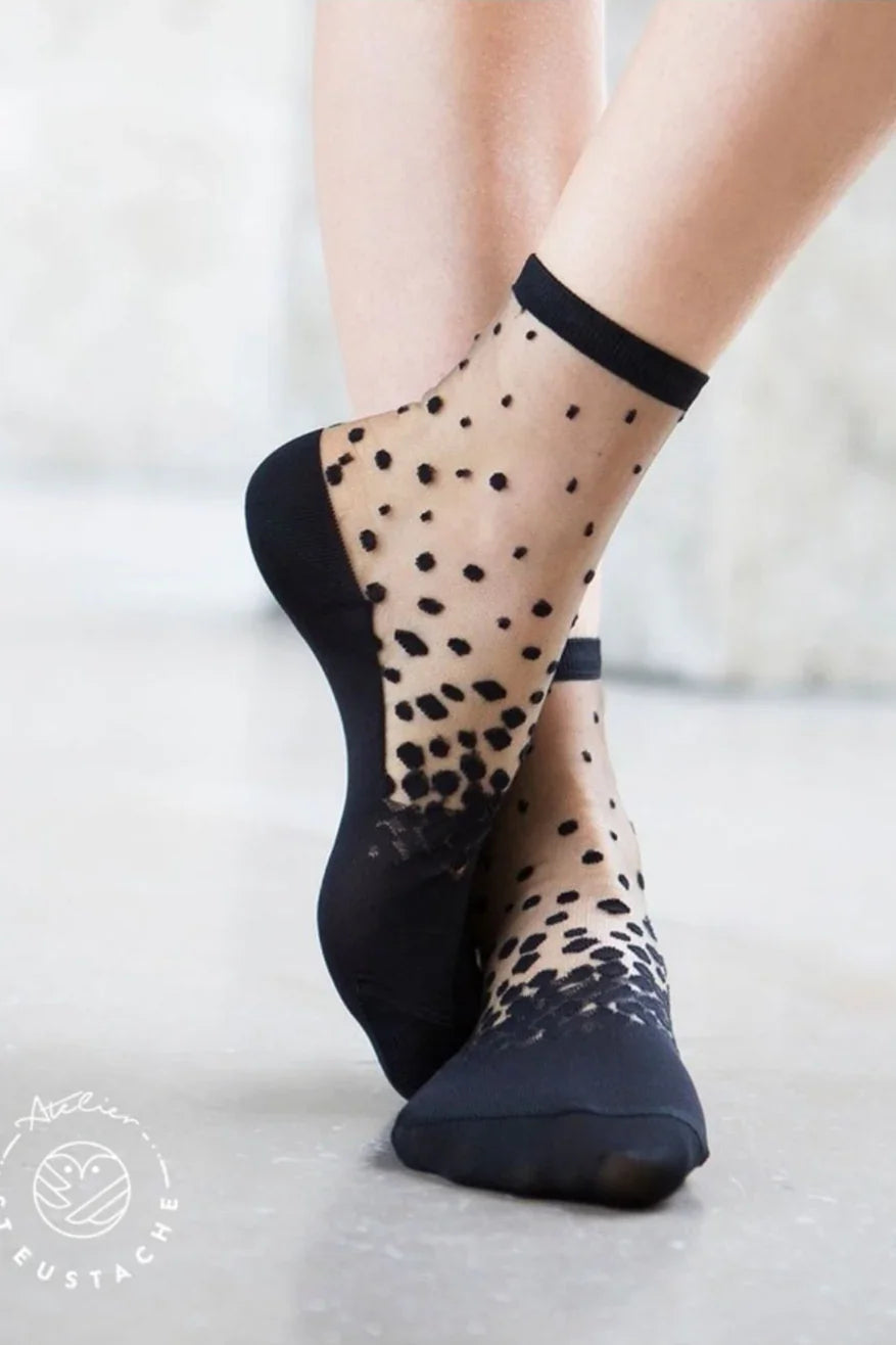 Sheer black polka dot ankle socks with solid toe and heel, modern fashion style