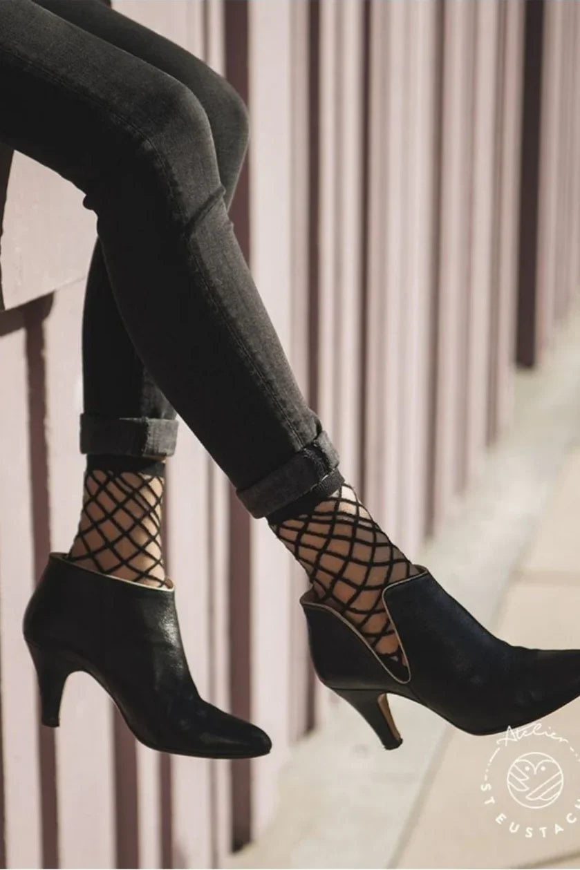Black ankle boots with fishnet socks and rolled black jeans, Love Classic fashion style