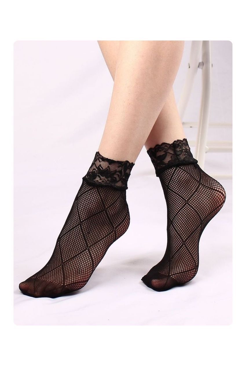 Black diamond-pattern mesh ankle socks with floral lace cuffs, worn on a model against a soft white background.
