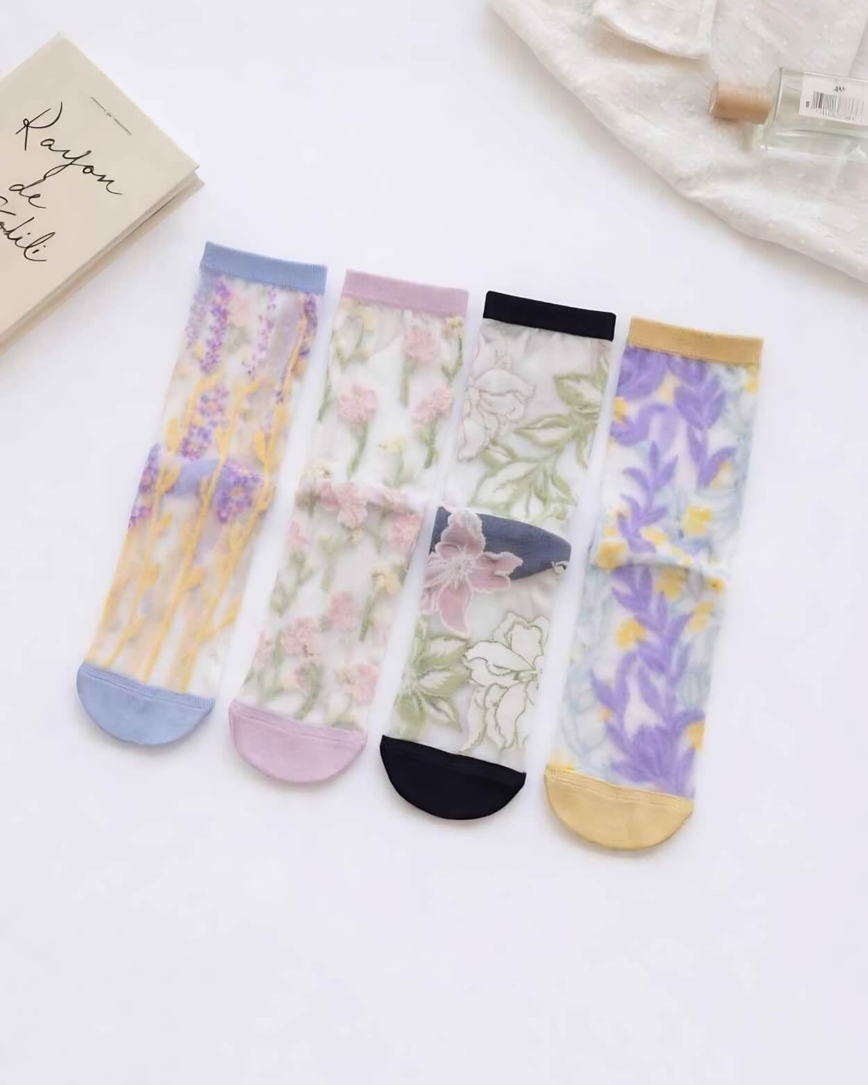 Floral Pattern Sheer Socks 4-Pack featuring translucent mesh fabric with assorted botanical prints, soft colored cuffs, and reinforced toe accents, displayed together on a clean white surface with lifestyle props, highlighting delicate floral style and lightweight everyday comfort.
