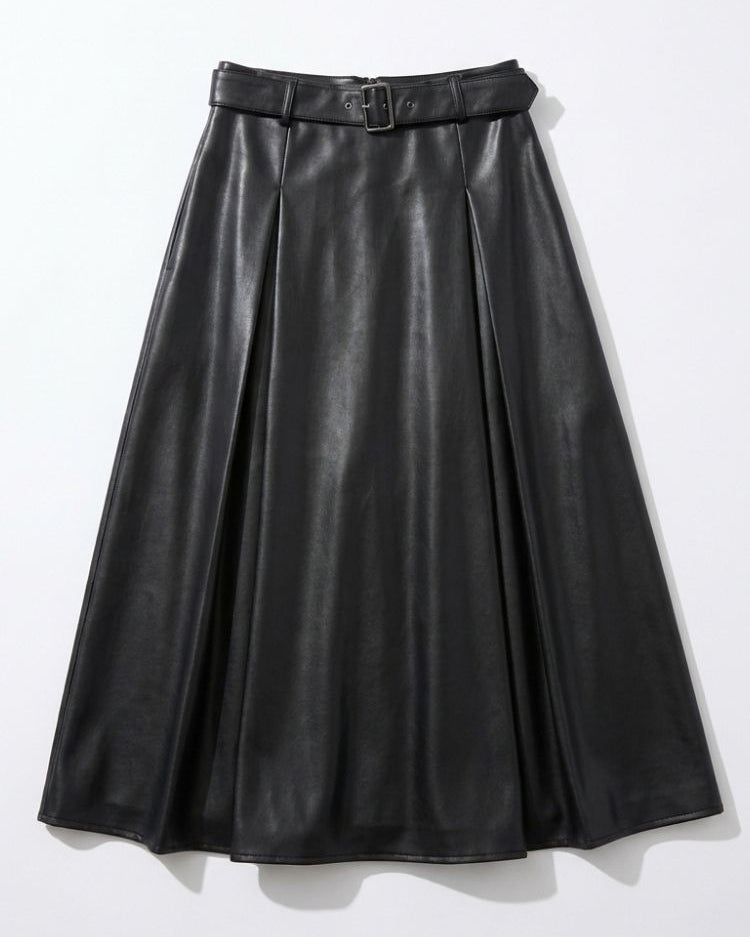 Saskia Skirt, high-waist midi skirt in black PU with structured pleats and a belted waistband, shown in a front view against a neutral background, highlighting the A-line silhouette, smooth finish, and voluminous drape.