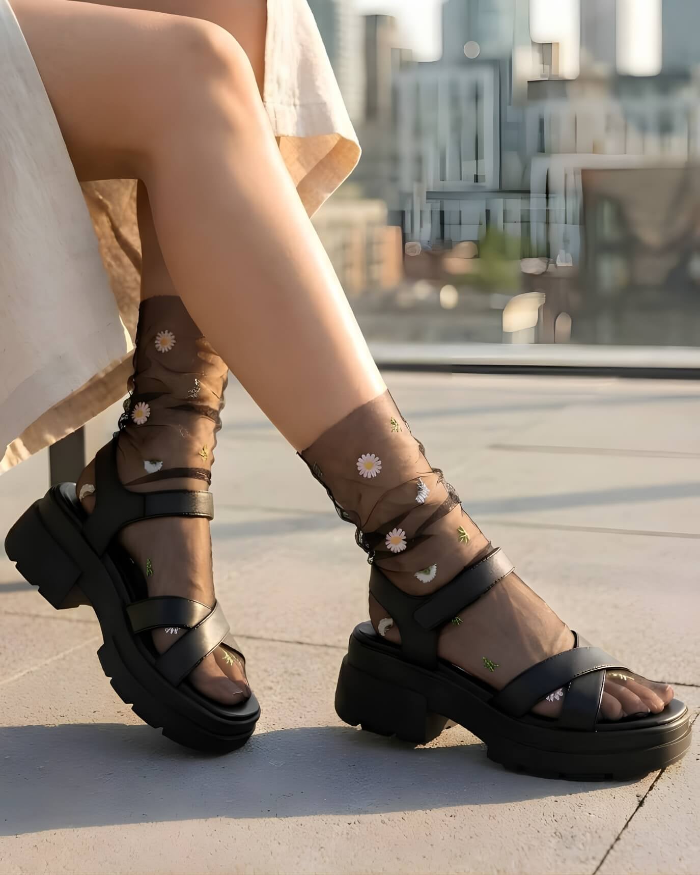 Sheer Garden Daisy Crew Socks in black sheer mesh with daisy embroidery, paired with black platform sandals to highlight bold contrast styling.