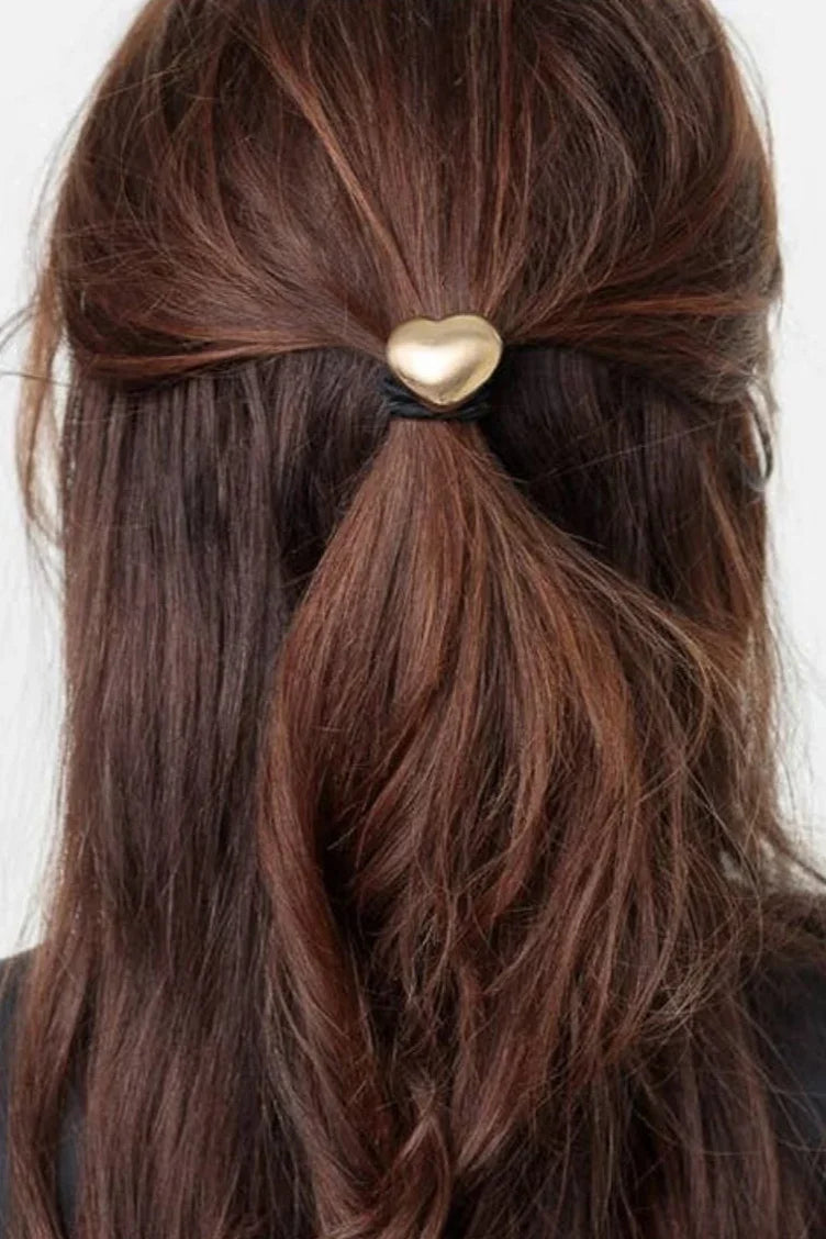 Brown hair styled with a gold heart hair tie, classic accessory from Love Classic