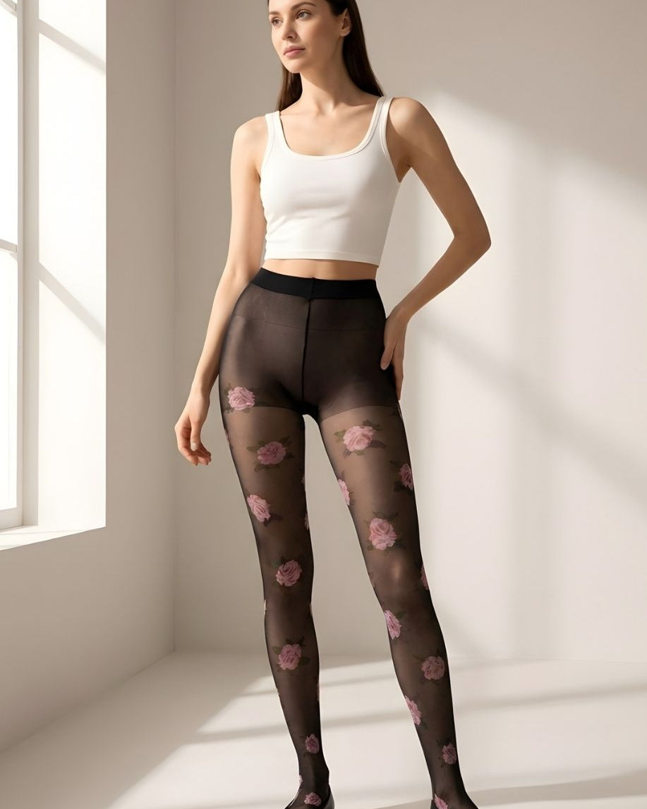 Romantic Rose Print Sheer Tights featuring a lightweight black transparent fabric with soft stretch fit and scattered pink rose pattern, shown full-length on a model in a minimal sunlit studio setting.
