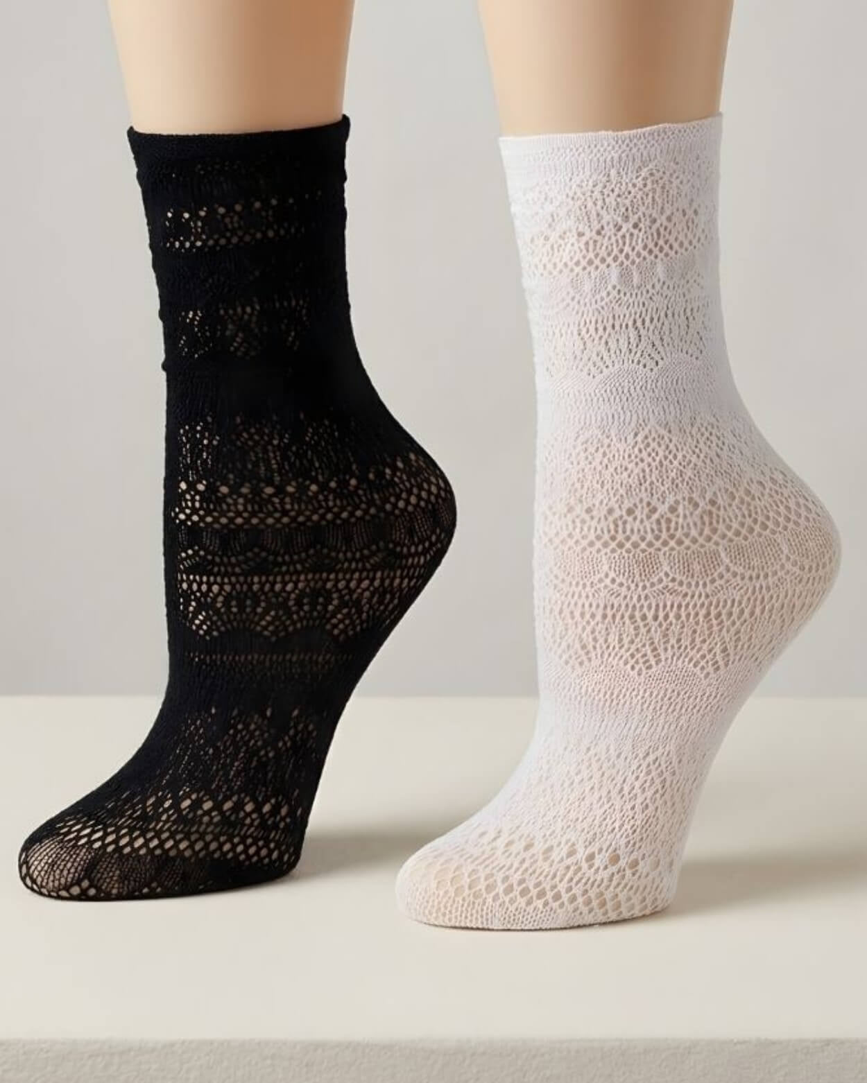 Lace Pattern Sheer Sock featuring ankle-length sheer knit socks with intricate lace-style patterning in black and white, displayed on raised feet against a neutral background, highlighting breathable texture, stretch fit, and lightweight comfort.