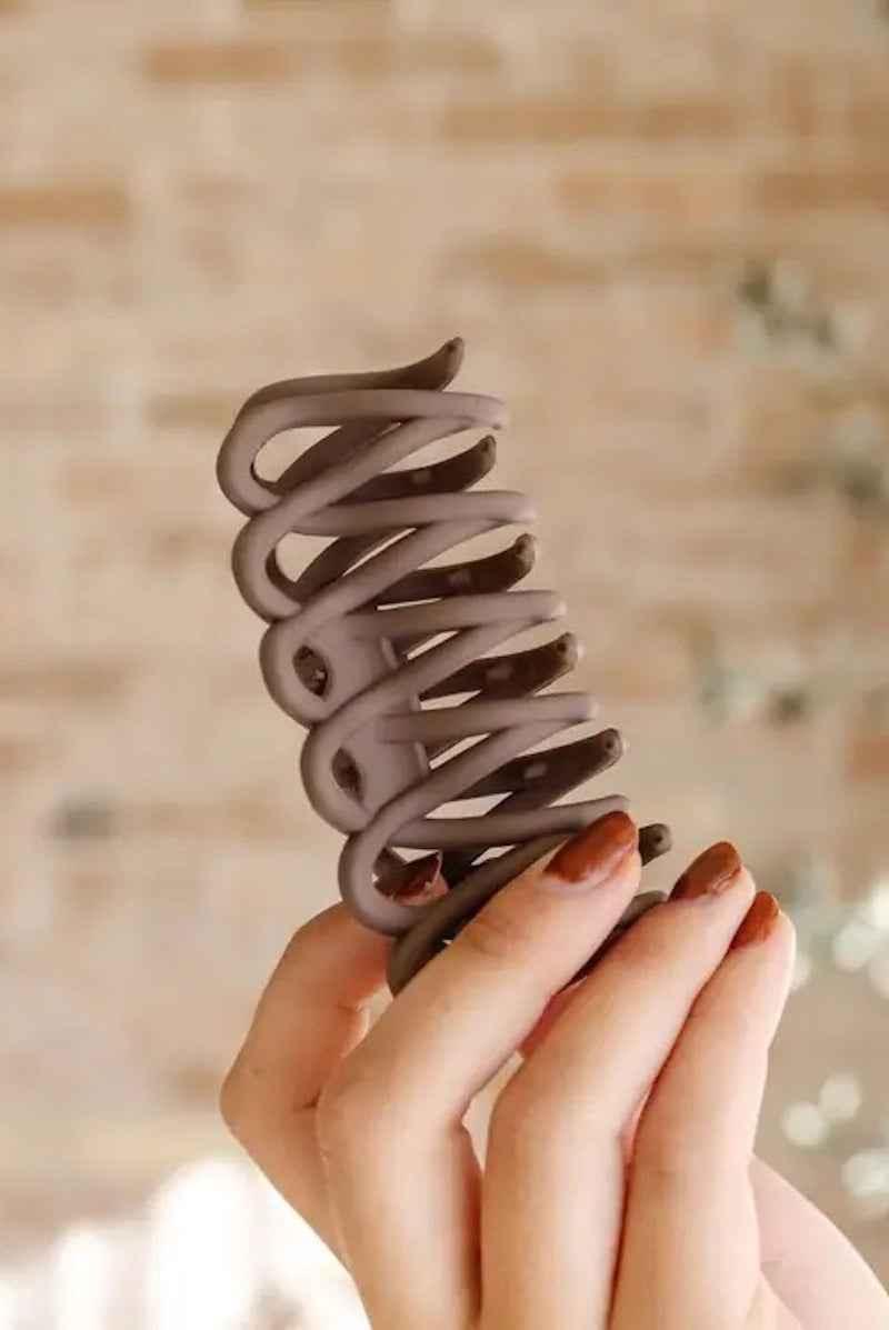 Woman holding matte brown hair claw clip, Love Classic stylish accessory