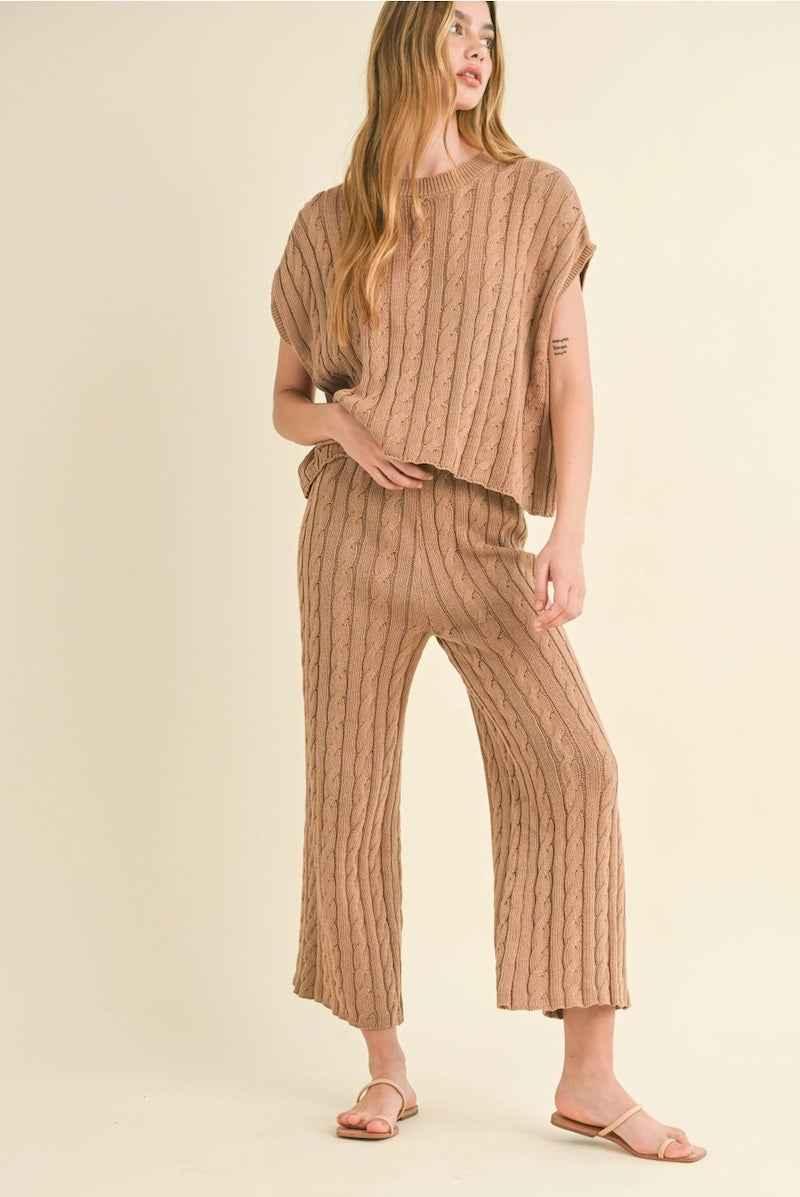 Woman wearing a beige cable knit lounge set from Love Classic, stylish cozy outfit