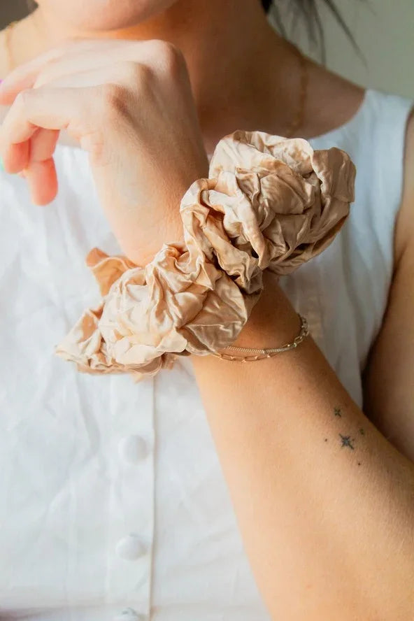 Woman wearing beige scrunchies and gold bracelet, showcasing Love Classic high quality style
