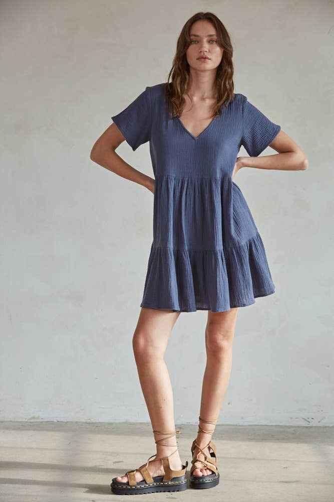 Woman wearing a short blue V-neck dress and sandals, Love Classic high quality style
