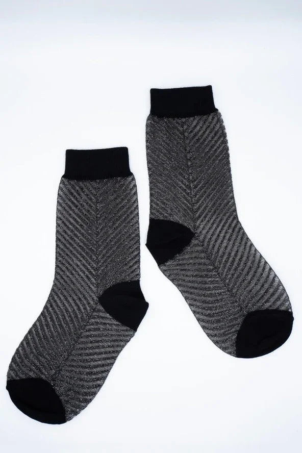 Pair of sheer black socks with chevron pattern and solid black heels, toes, and cuffs