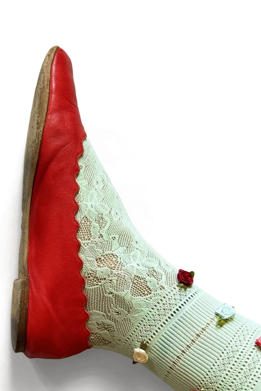 Red leather flat shoe paired with mint green lace sock and small floral accents from Love Classic