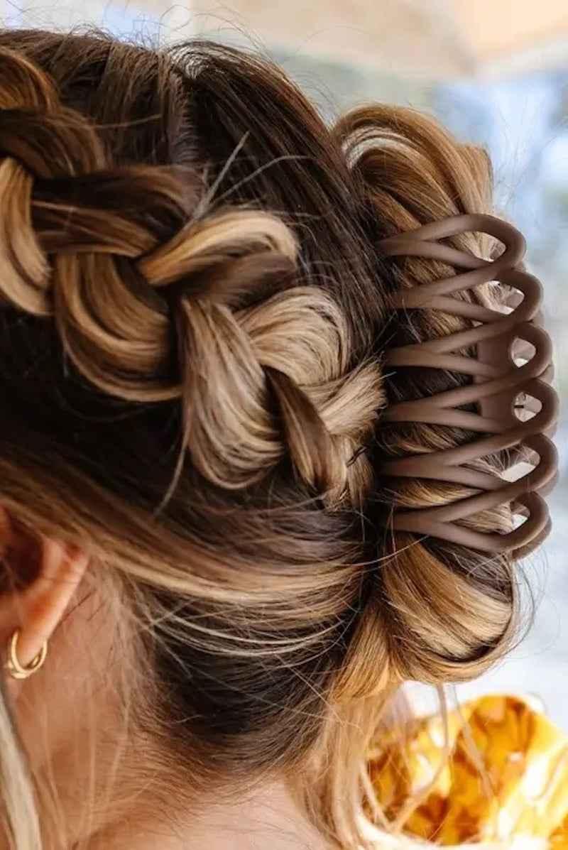 Woman with braided hair in a bun secured by a large brown hair claw clip, Love Classic style