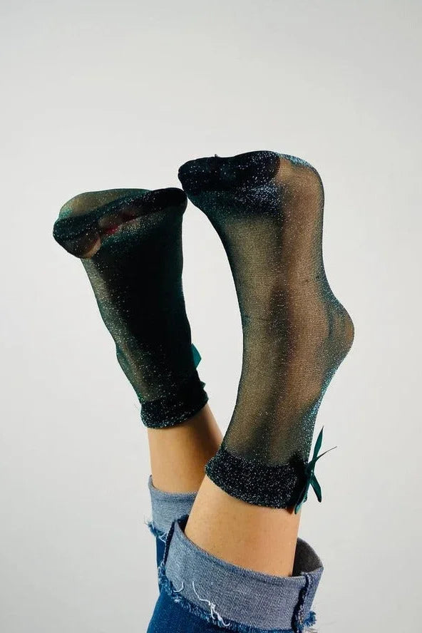 Sheer glitter socks with green bows from Love Classic, styled with rolled jeans