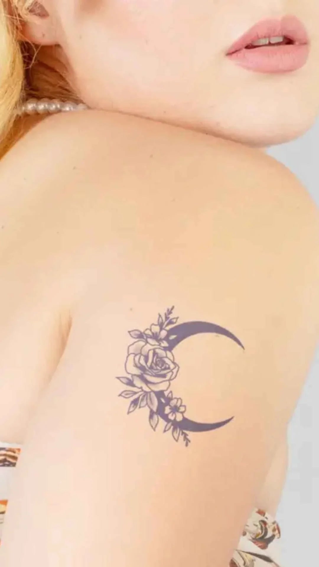 Woman with crescent moon and rose shoulder tattoo, Love Classic style, close-up