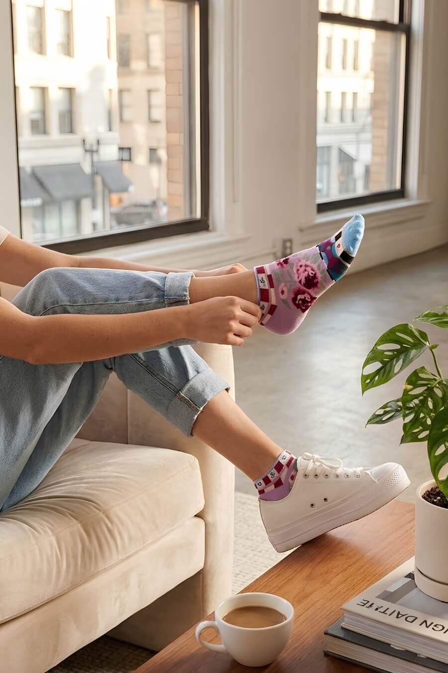 Dolce Vita Ultra-Short Sock featuring a snug ultra-short silhouette with floral rose graphics and colorful patterned accents, worn with casual sneakers while relaxing on a velvet sofa in a bright loft space, highlighting comfort and laid back everyday wear.