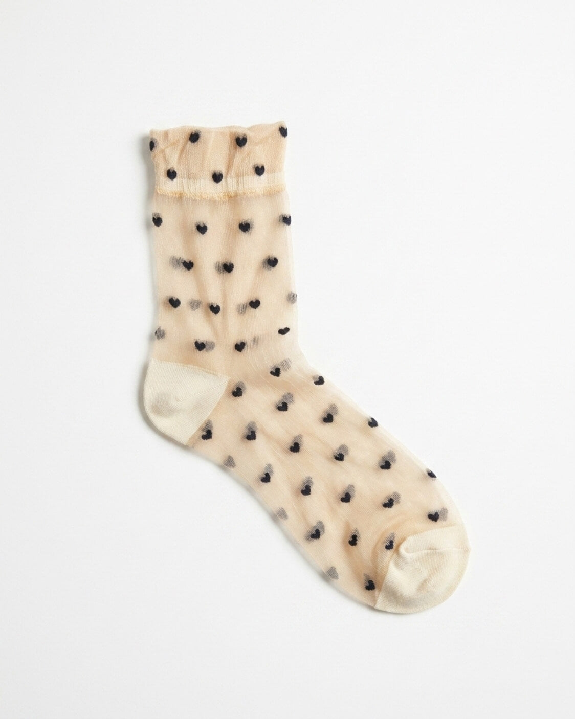 Blushing Hearts Sheer Socks featuring a sheer ankle sock with small black heart accents, soft ribbed cuff and reinforced toe and heel panels, displayed flat on a clean studio background, highlighting the transparent finish and delicate dotted heart styling.