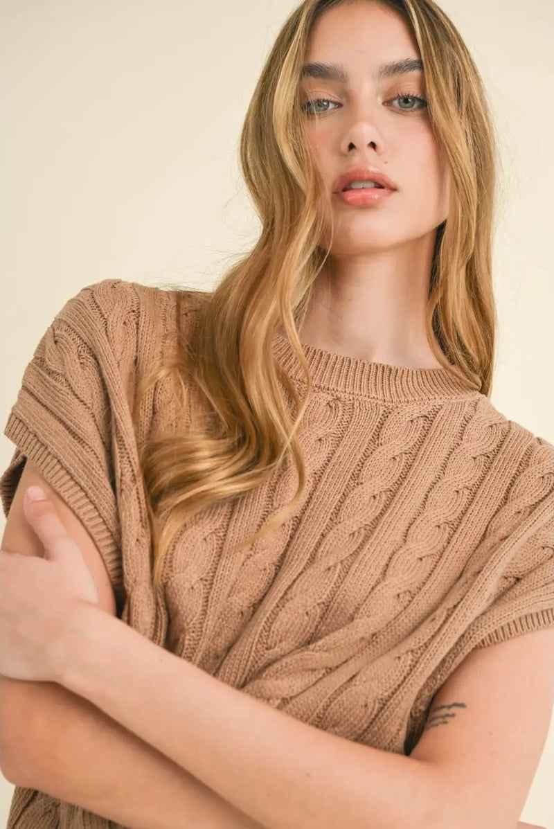 Woman wearing a beige cable knit sweater, Love Classic cozy fashion style