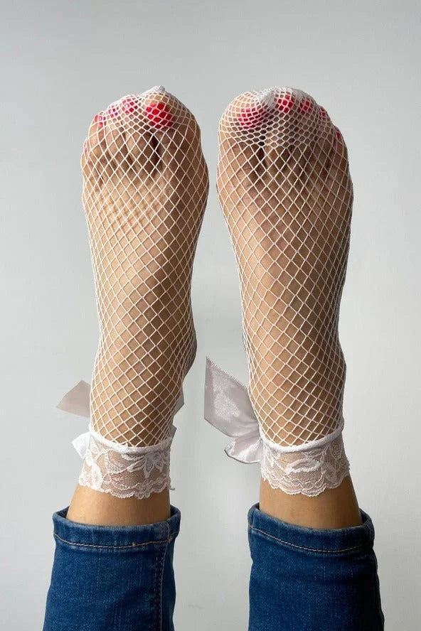 White fishnet lace socks with ribbon bows, worn with jeans, Love Classic style