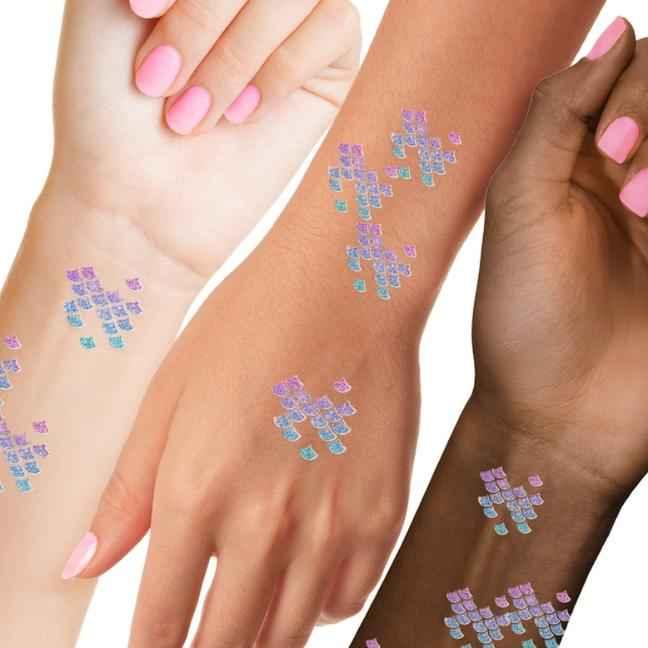 Colorful crystal heart-shaped tattoos on diverse wrists with pink manicured nails, Love Classic