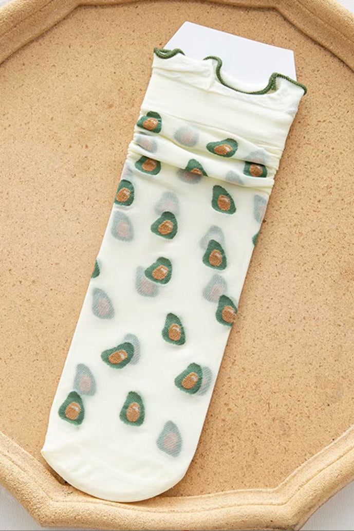 Sheer mesh crew socks featuring a playful pattern with a soft lettuce-edge cuff on a neutral background.