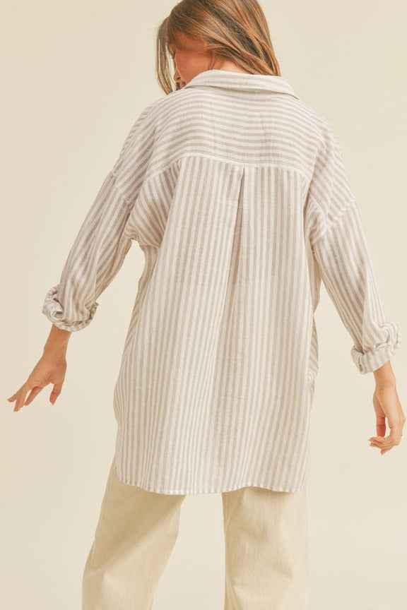 Woman wearing a loose striped shirt and cream pants, Love Classic fashion style