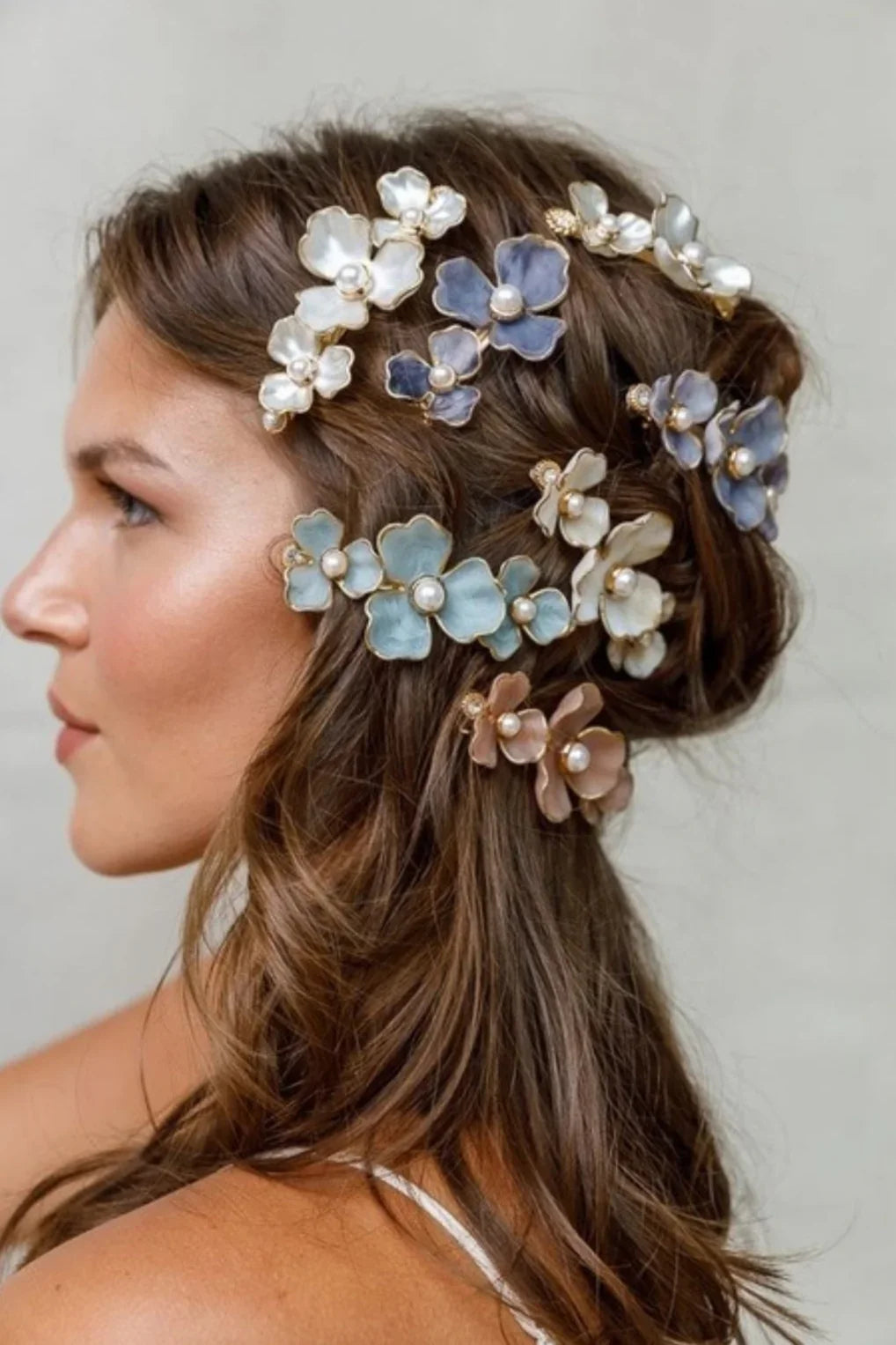 Woman with wavy brown hair adorned in pearl and pastel floral hair accessories, Love Classic style