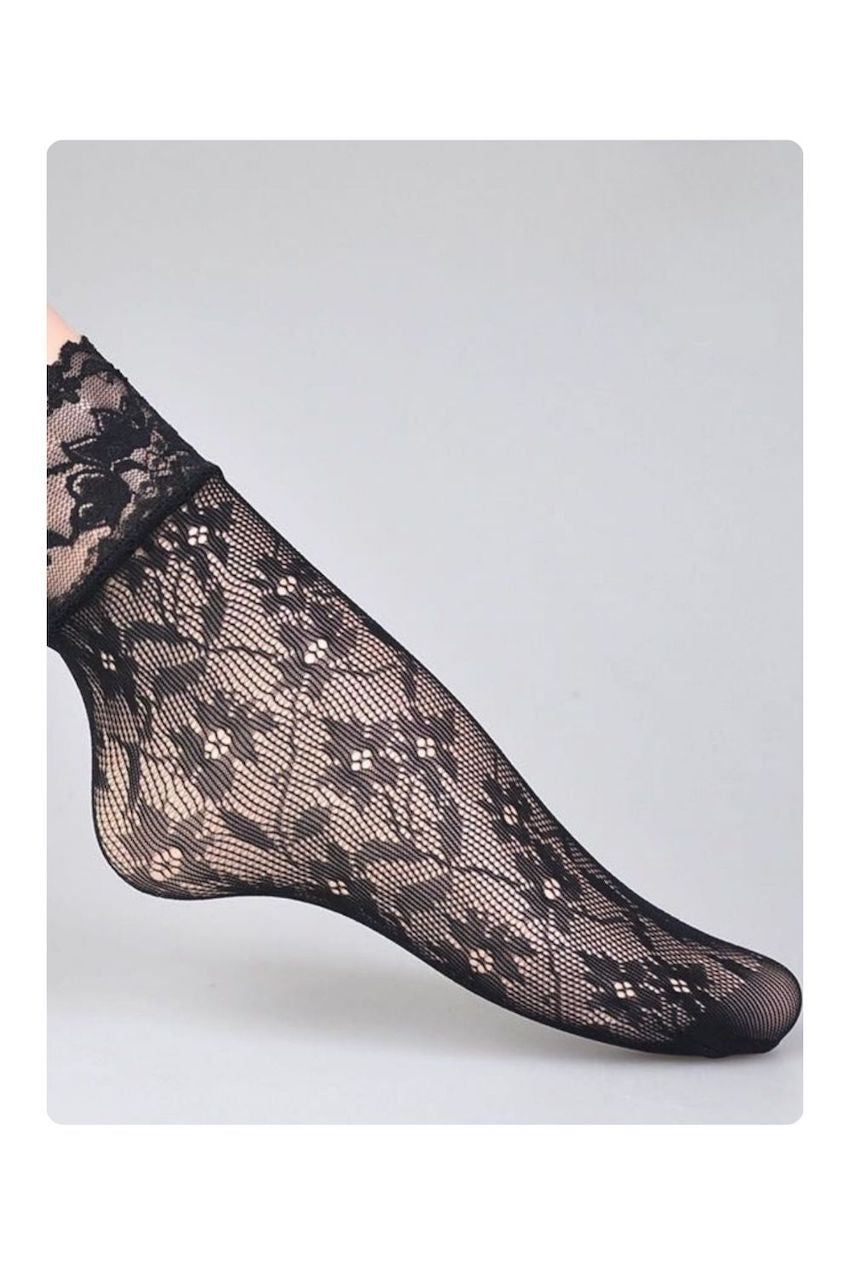 Black floral lace mesh ankle socks with a scalloped lace cuff, shown on a model against a light gray background.