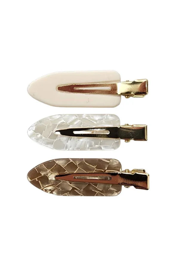 Set of three Love Classic hair clips in cream, clear, and brown patterns with gold clasps