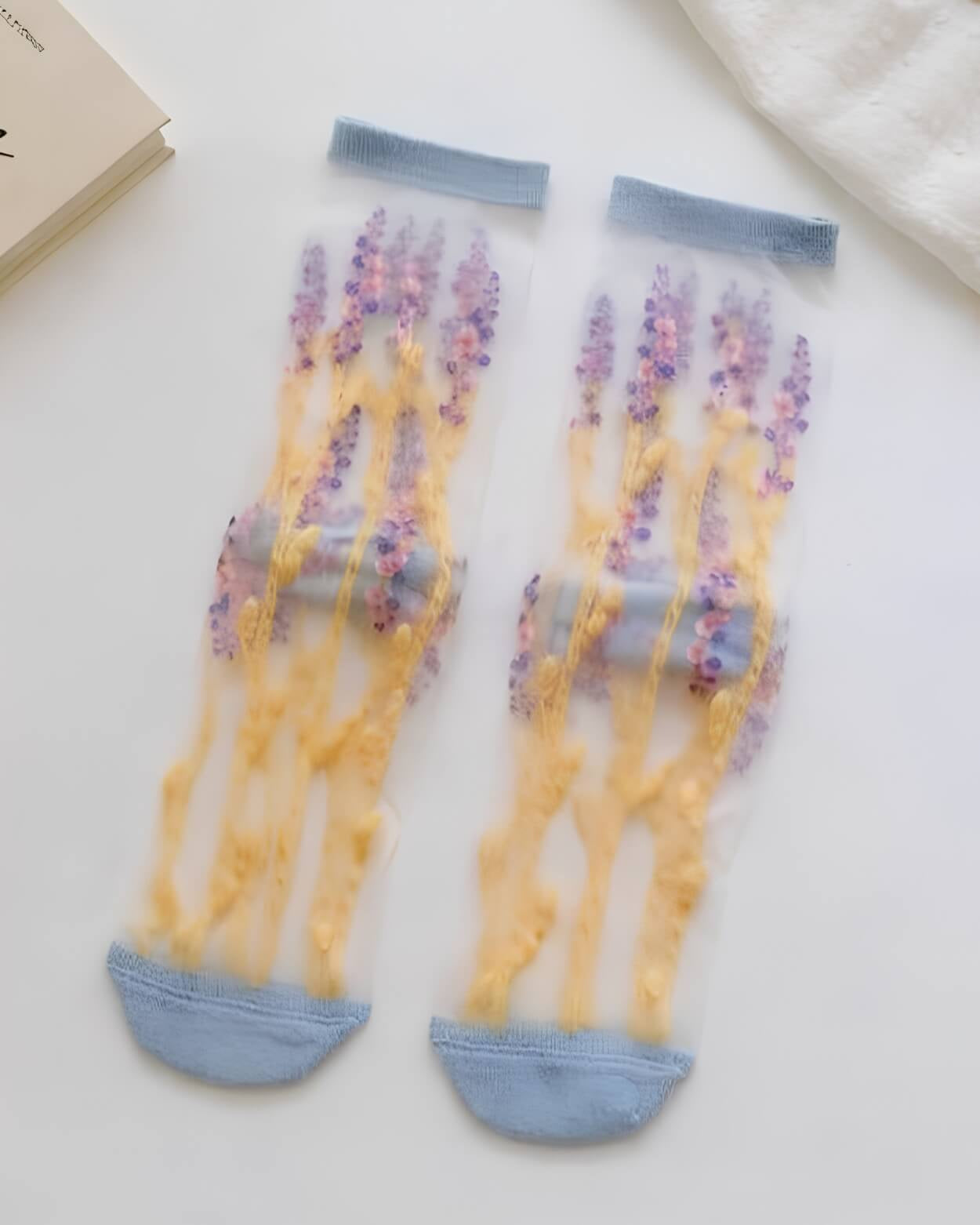 Floral Pattern Sheer Socks 4-Pack featuring lavender-inspired floral stems on transparent mesh with pale blue cuffs and reinforced toes, displayed flat as a matching pair, highlighting soft breathability and fresh botanical charm.