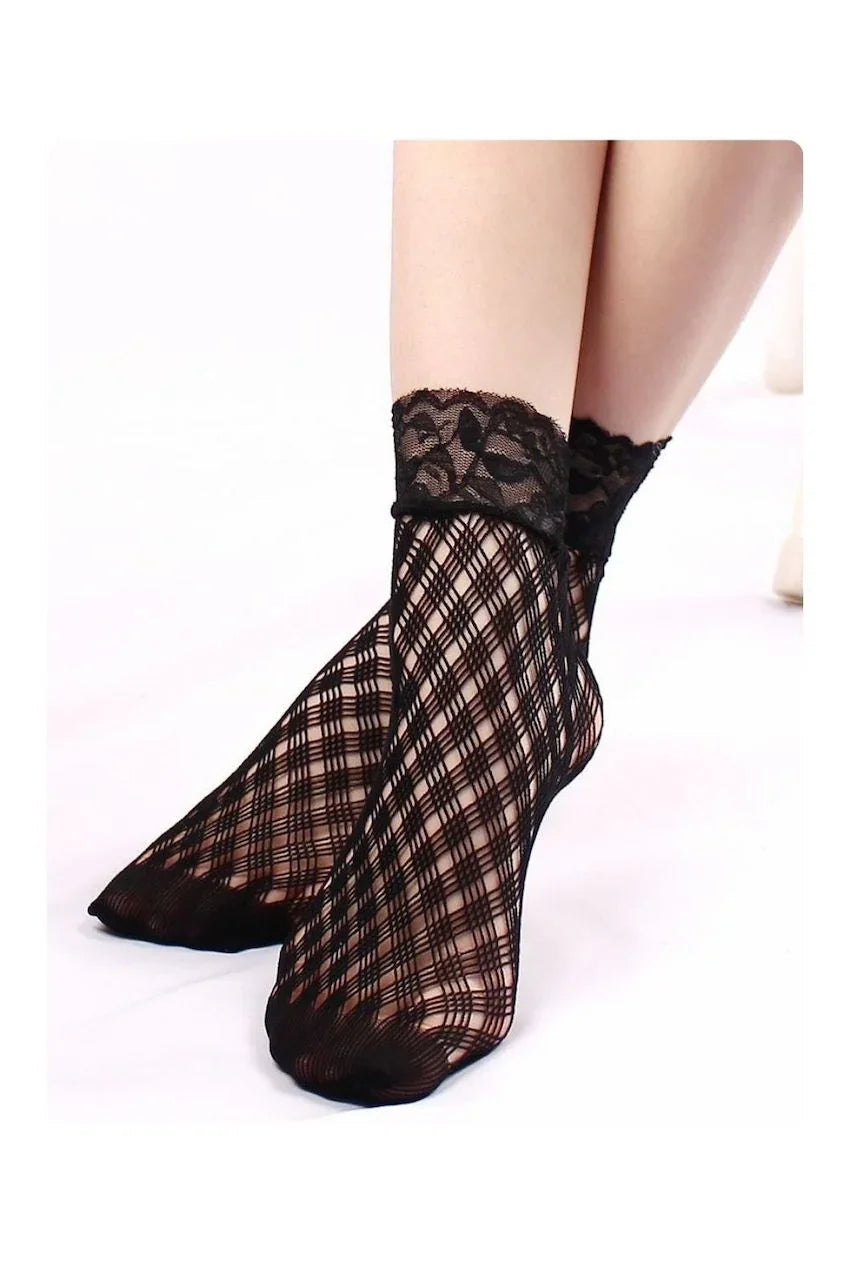 Black crisscross mesh ankle socks with floral lace cuffs, worn on a model against a white background.