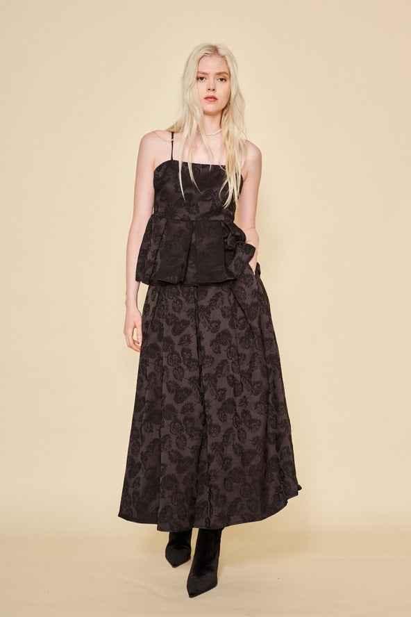 Woman modeling Love Classic black floral jacquard top and skirt set, neutral background