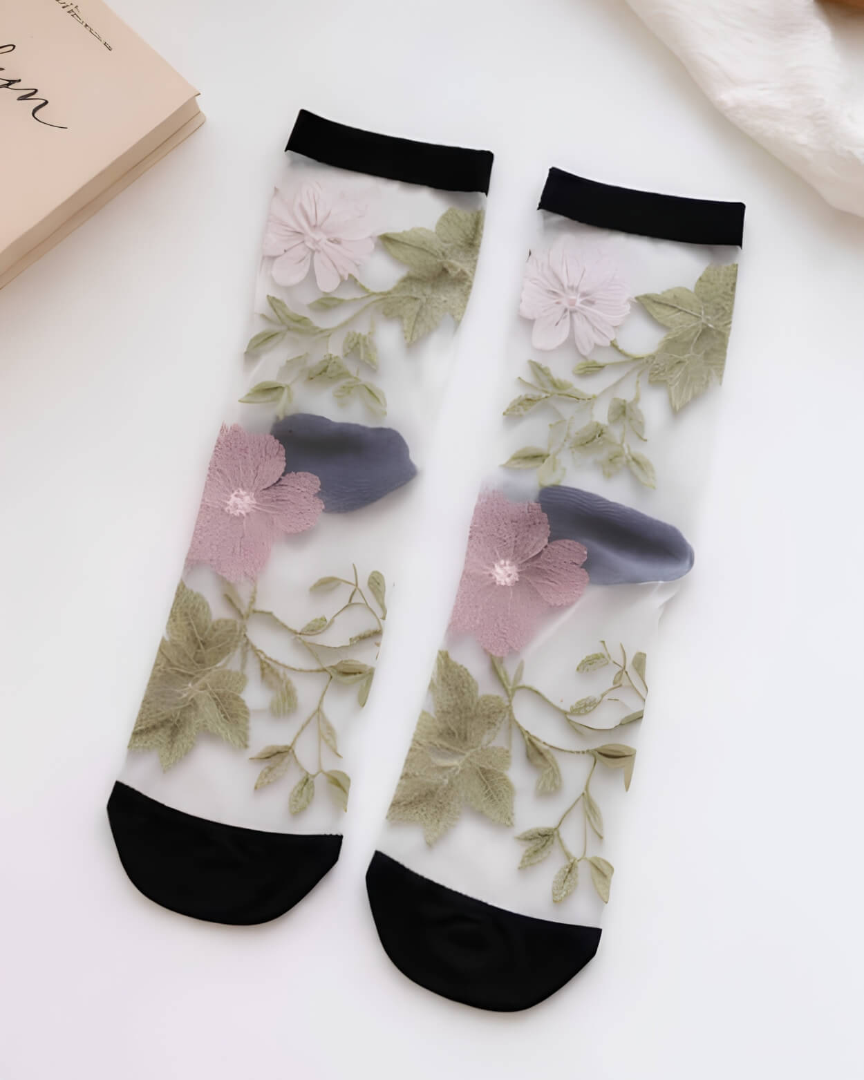 Floral Pattern Sheer Socks 4-Pack featuring embroidered-style pink and white flowers with green leaf detailing on sheer mesh, finished with black cuffs and toe accents, highlighting elegant contrast and delicate garden-inspired styling.