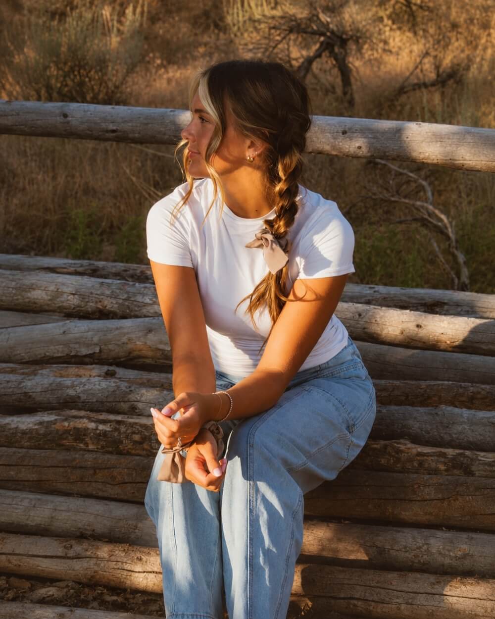 Model wearing the Chestnut Bow Scrunchie in a centipede braid hairstyle featuring a soft brown tone and decorative bow detail for added charm.
