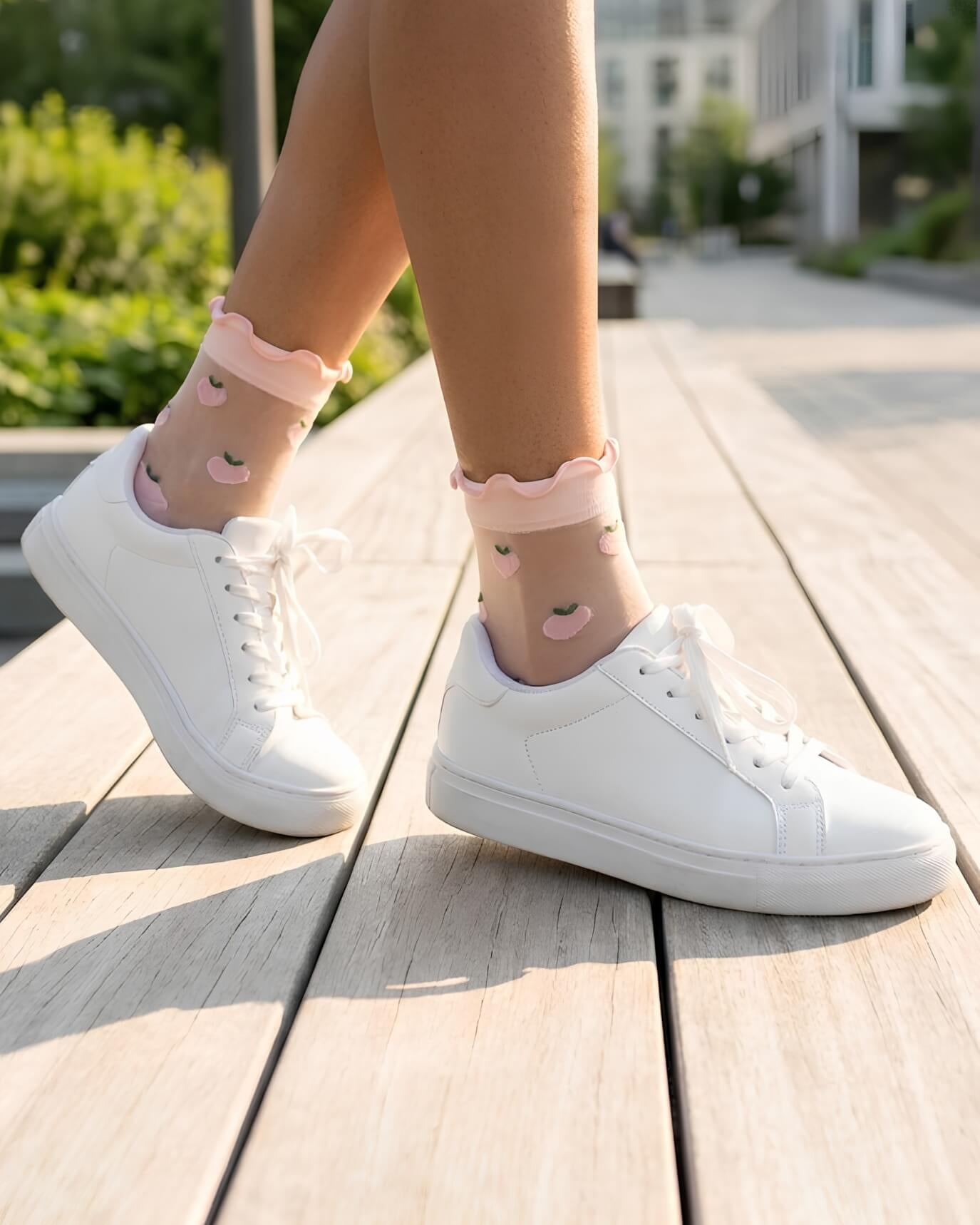 Whimsical Ruffle Edge Sheer Socks featuring a sheer ankle-length fit with embroidered peach motifs and soft pink ruffle cuffs, paired with white sneakers during a casual outdoor walk, highlighting lightweight comfort and everyday fashion pairing.