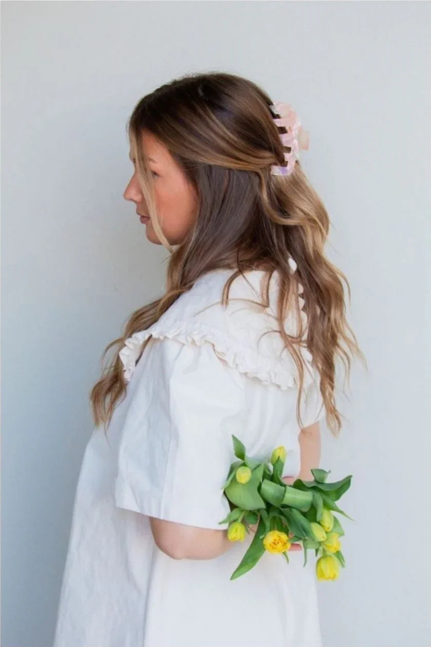 Woman in white ruffled dress with wavy hair and yellow tulips, Love Classic style